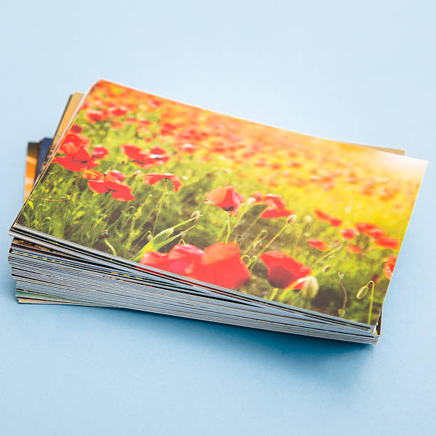 Stack of printed colorful images in spring field http://blogtoscano.altervista.org/sol.jpg printing out photos stock pictures, royalty-free photos & images