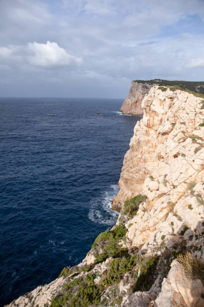 Alghero, Sassari , Italy; 3rd August 2022: Panoramic view of cape Cacia, Sardinia, Italy; from the top of a hill near Neptune's cave. Sunny midday with a turquoise Mediterranean Sea on the horizon..