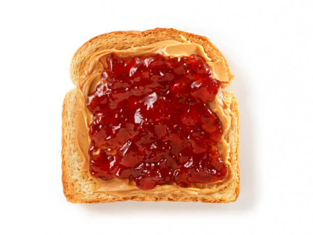 Peanut Butter and Jam on Toast Peanut Butter and Strawberry Jam on Toast with Natural Drop Shadow- Photographed on Hasselblad H3D2-39mb Camera raspberry jam stock pictures, royalty-free photos & images