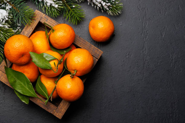 istock Festive citrus joy: Tangerines in a holiday-themed box 1852768487