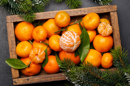 Festive citrus joy: Tangerines in a holiday-themed box, flat lay