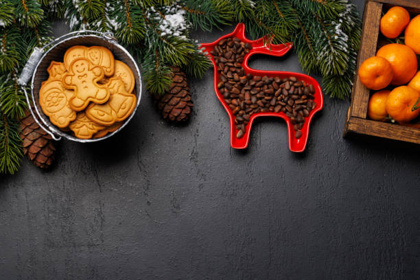 istock Christmas background with fir tree, gingerbread cookies, nuts, and copy space for greetings 1852770590