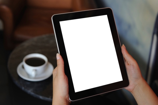 Woman holding digital tablet with blank screen.