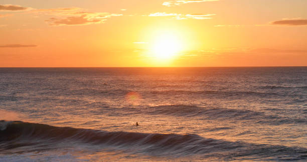 istock Scenic view of distant surfer 1852773924