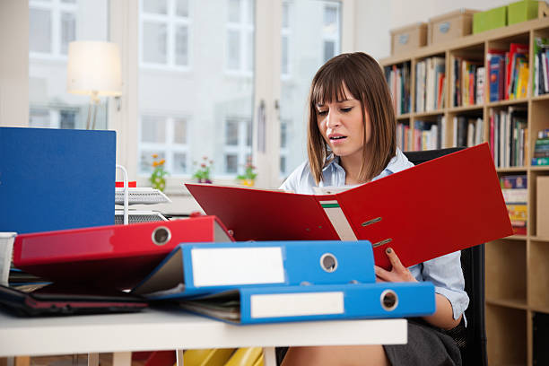 istock Young Woman at Work - with Ringbinders 185277434