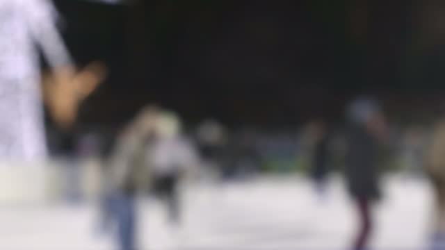 Blurred ice rink with people skating