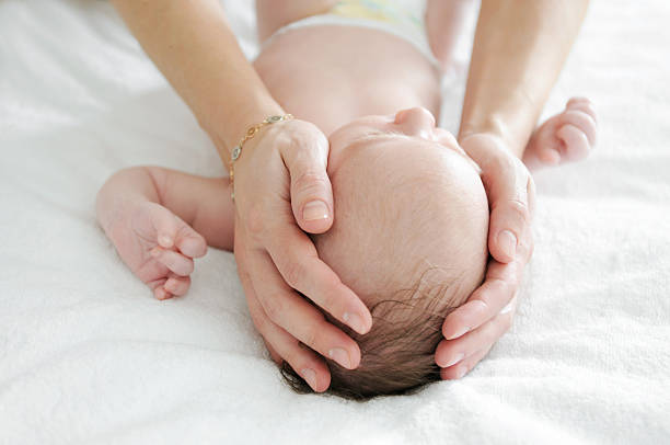 istock A mother cradling her baby's head 185277816