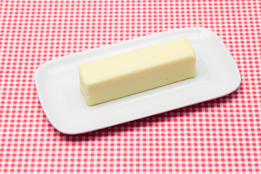Whole stick of fresh butter on a dish