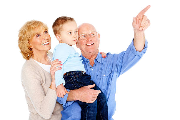 Full length profile shot of a grandson and grandfather gesturing high-five isolated on white background