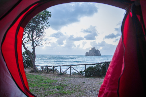 View through tent to empty beach and sea