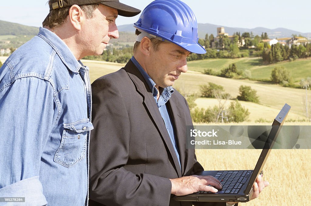 Engineer and Farmer Planning in the Countryside Engineers in the countryside Agriculture Stock Photo