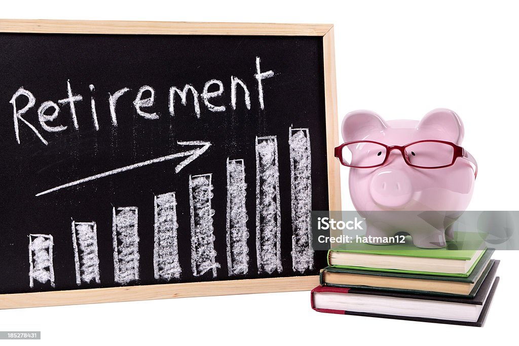Piggy Bank with retirement savings chart Pink piggy bank with glasses standing on books next to a blackboard with retirement savings chart.  Sharp focus on the piggy bank.  Alternative file shown below: 401k - Single Word Stock Photo