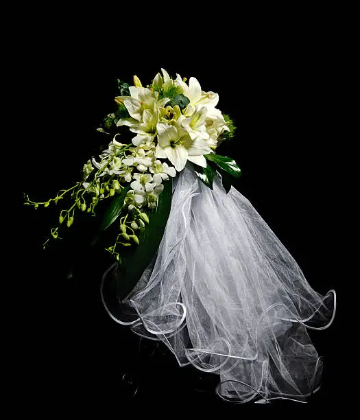 bride bouquet with white iris and cymbidium on black background.