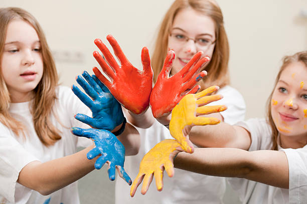 istock Three girls with hands full of paint 185279033