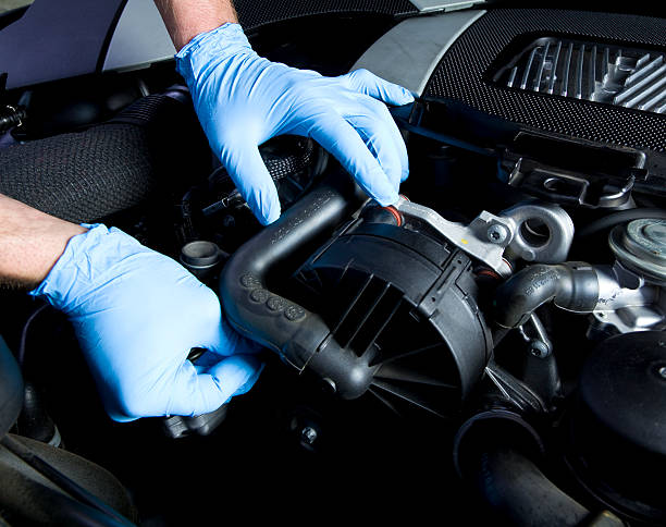 Auto Repair Auto mechanic working on car. CLICK TO SEE MORE! car mechanic top view stock pictures, royalty-free photos & images