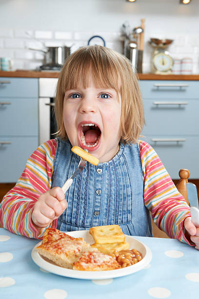istock Young Girl Enjoying Unhealthy Lunch 185279843
