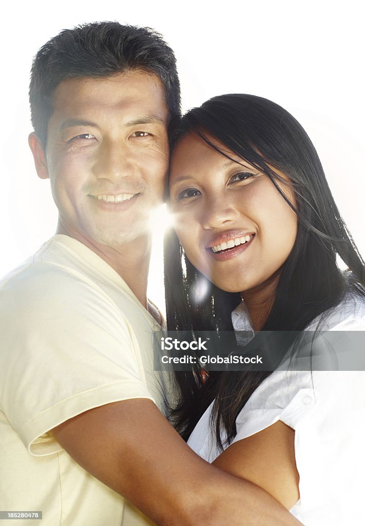 Our love shines like the sun Portrait of a young affectionate asian couple on a white background Adult Stock Photo