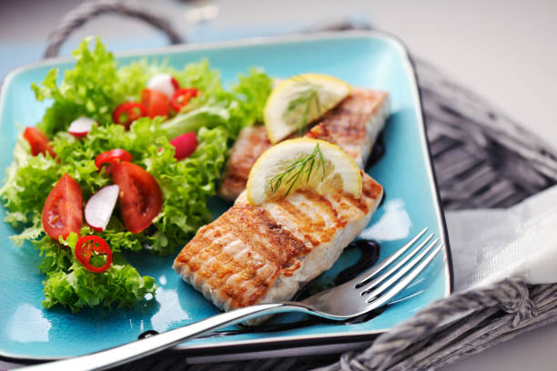 istock Grilled Salmon steak with fresh salad and balsamic vinegar sauce 185280526