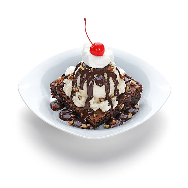 Brownie Sundae Hot fudge brownie sundae on white with shadow. whipped food photos stock pictures, royalty-free photos & images