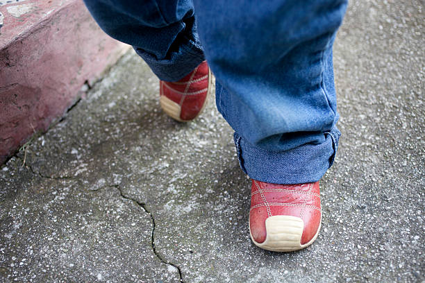 istock Baby walking with red shoes 185280599
