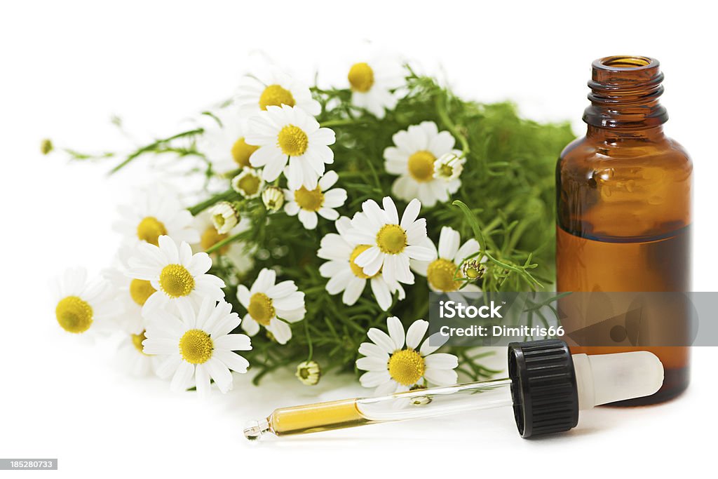 Herbal Medicine: Chamomile "Chamomile flowers, open glass bottle and pipette with tincture on white background.Related pictures:" Chamomile Stock Photo