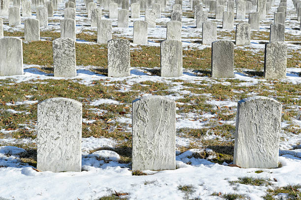 istock Cemetery Graves and Headstones in Rows, Winter Snow 185280777