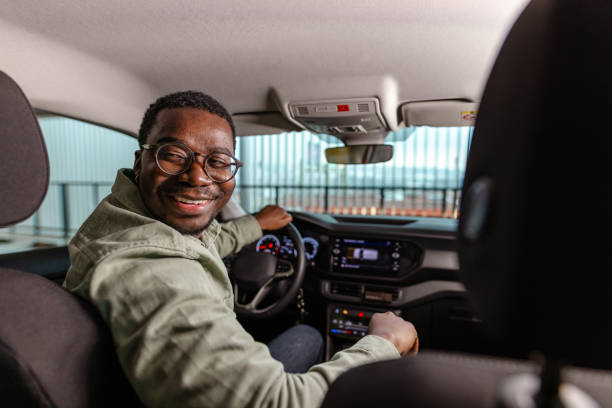 istock Man parking his car and looking back while reversing 1852808234