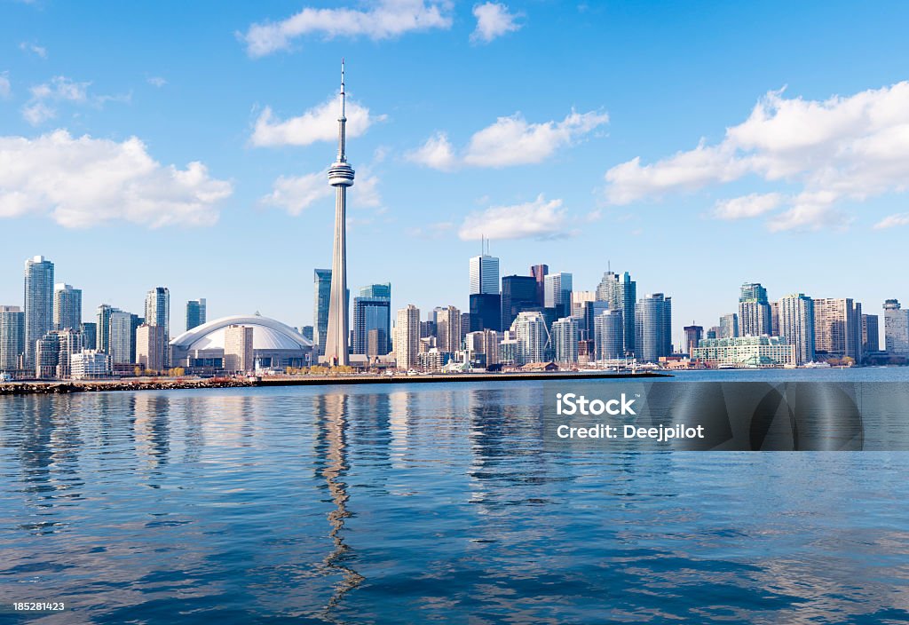 Toronto City Skyline in Canada Toronto city skyline, Canada. Downtown area under blue skies and white clouds, reflection in the still waters. Toronto Stock Photo