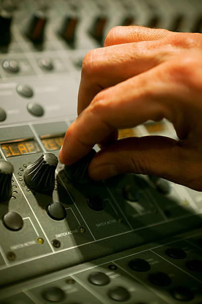 istock Hand turning a knob in professional mixer 185281484