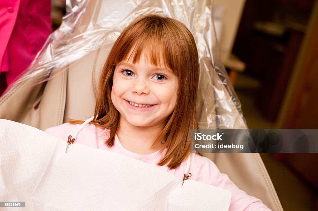 Chica feliz sentado en la silla Dental dentista oficina en - Foto de stock de 4-5 años libre de derechos