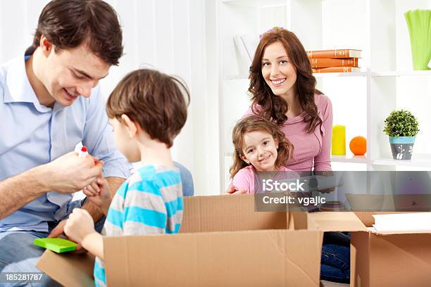 Family Moving Into New House Stock Photo - Download Image Now - 30-39 Years, 4-5 Years, Adult