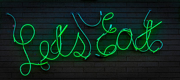 istock Route 66 Neon Green Let's Eat Restaurant Sign 185282136