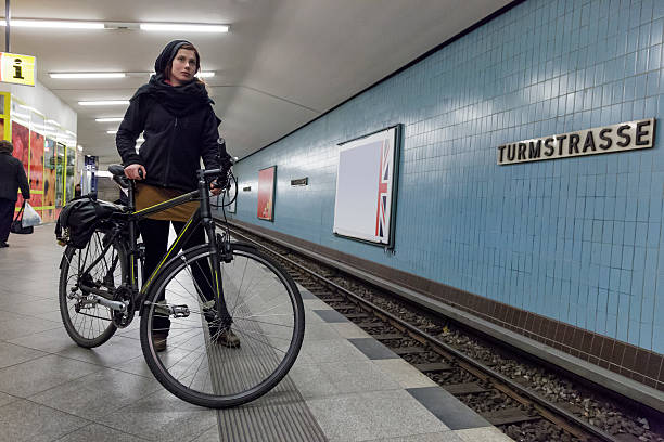Woman commuter waiting for an U-Bahn at the Turmstrasse station in Berlin. Horizontal shot.