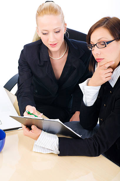 istock Two business woman working in office 185282315