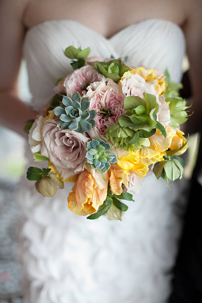 Bride holding springtime bouquet stock photo