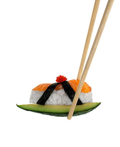 Eating Artisanal Sushi Maki Nigiri presented on elegant blocks