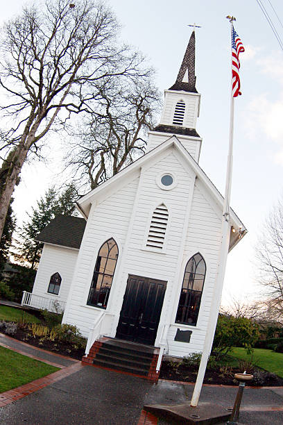 istock Front of White Painted Chapel, Steps, Door, Steeple, Flag 185282758