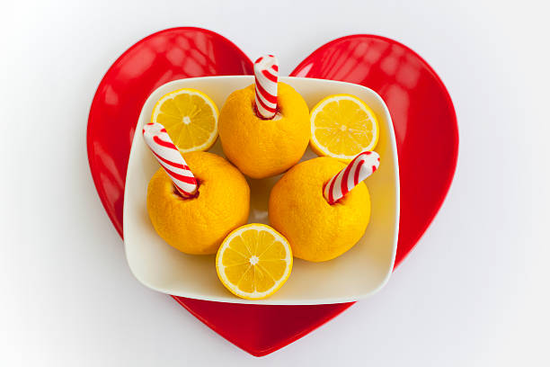 Summertime lemon and peppermint lemonade drink on red heart plate stock photo