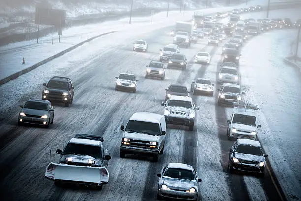 Heavy traffic on an icy snow covered highway.