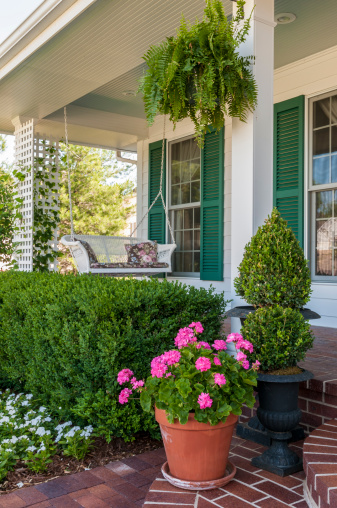 A white wicker porch swing.