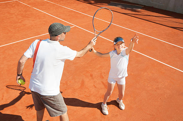 istock Young girl in training with tennis coach 185283618