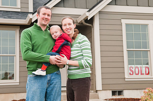 istock A family outside their first home posing for the camera 185283654