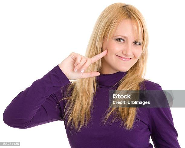 Smiling Woman Pointing At Face Stock Photo - Download Image Now - One Woman Only, Purple, Women