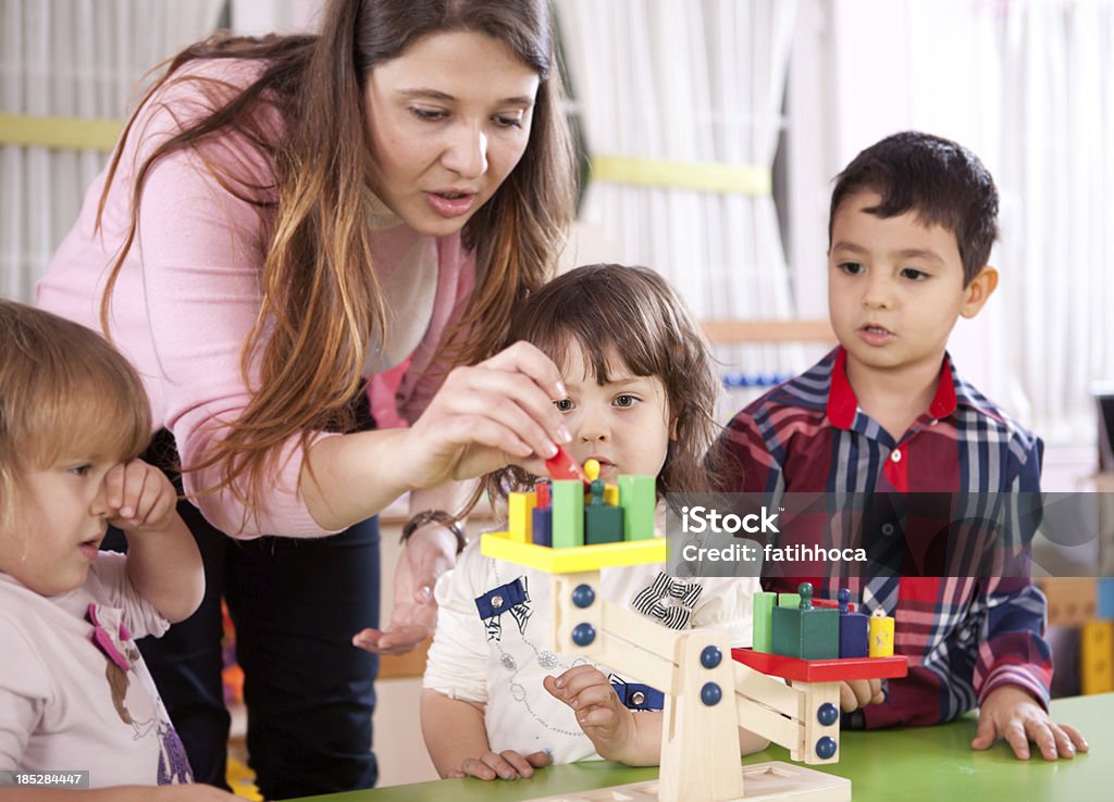 Preschoolers and Teacher Teacher and students in classroom. 4-5 Years Stock Photo