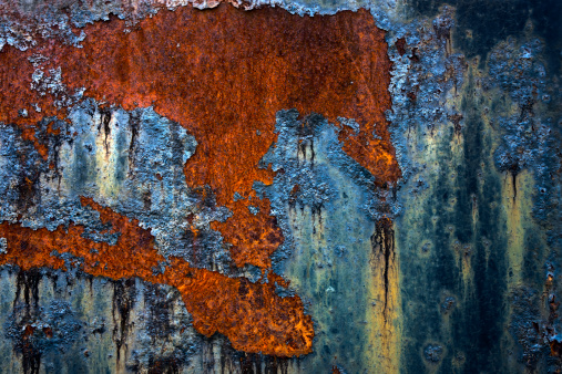 blue peeling paint on rusty metal,