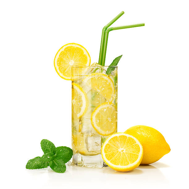 lemonade "glass of cold lemonade served and garnished, isolated on white background." lemonade stock pictures, royalty-free photos & images