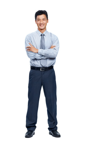 Friendly businessman isolated on white smiling at the camera with arms folded - copyspace