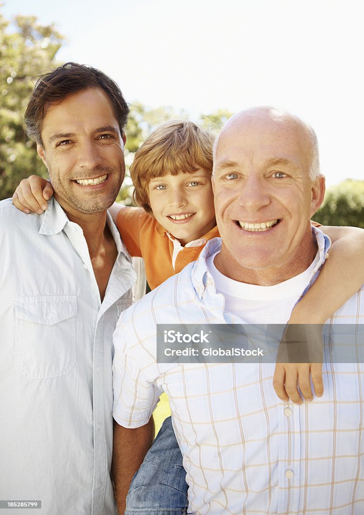 Sharing the heritage of our fathers Three male generations of one family smiling together - portrait Father Stock Photo