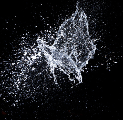 Picture of water exploding on a black backdrop.