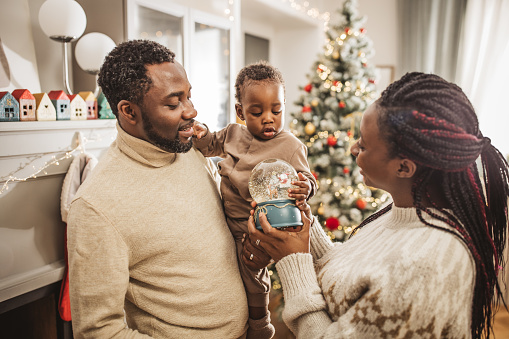 Family having fun at Christmas in decorated living room.